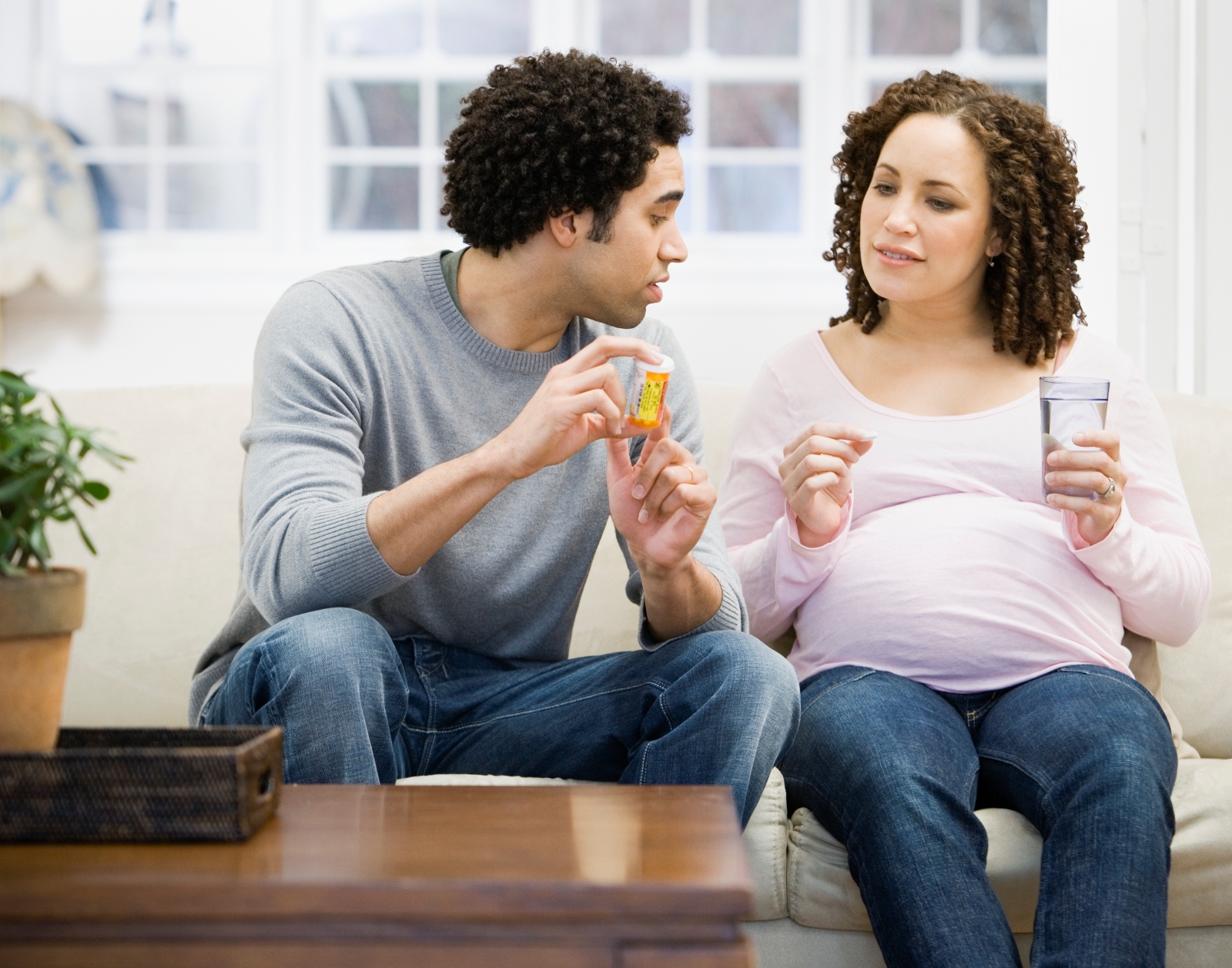 Man holding prescription for woman who is pregnant